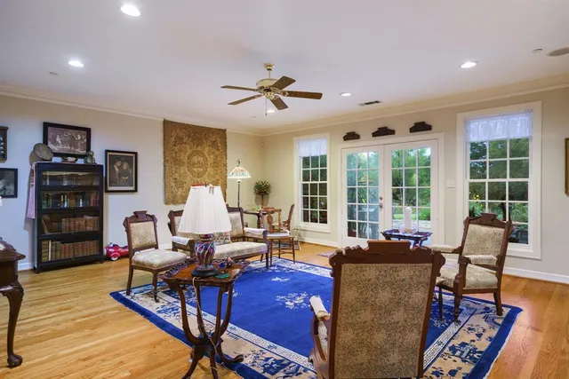 a living room with furniture fireplace and wooden floor