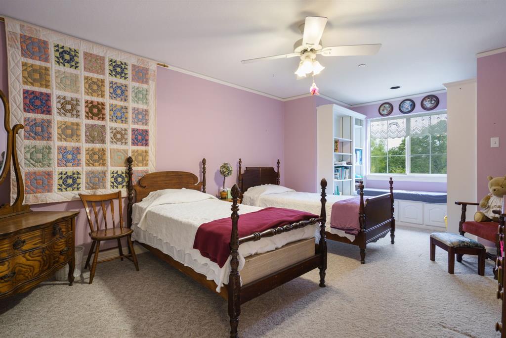 636 East Tripp Road Sunnyvale, TX 75182 - Photo 24 of 40 a bedroom with a bed and a chandelier