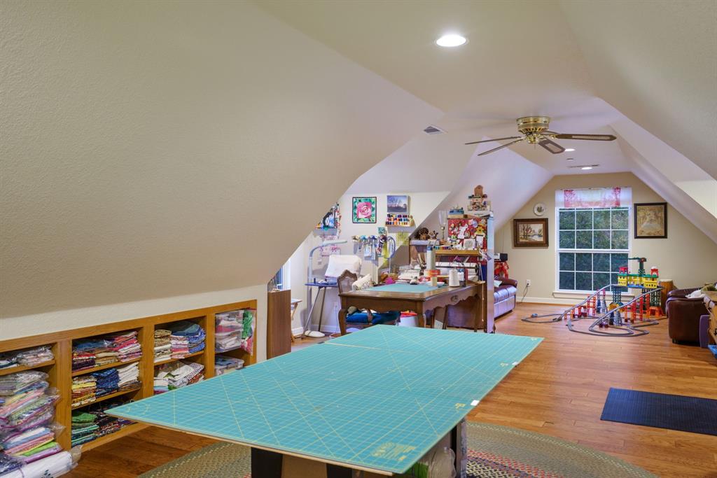 636 East Tripp Road Sunnyvale, TX 75182 - Photo 26 of 40 a view of a play room with furniture and a book shelf