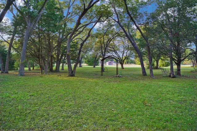 a backyard of a house with lots of green space
