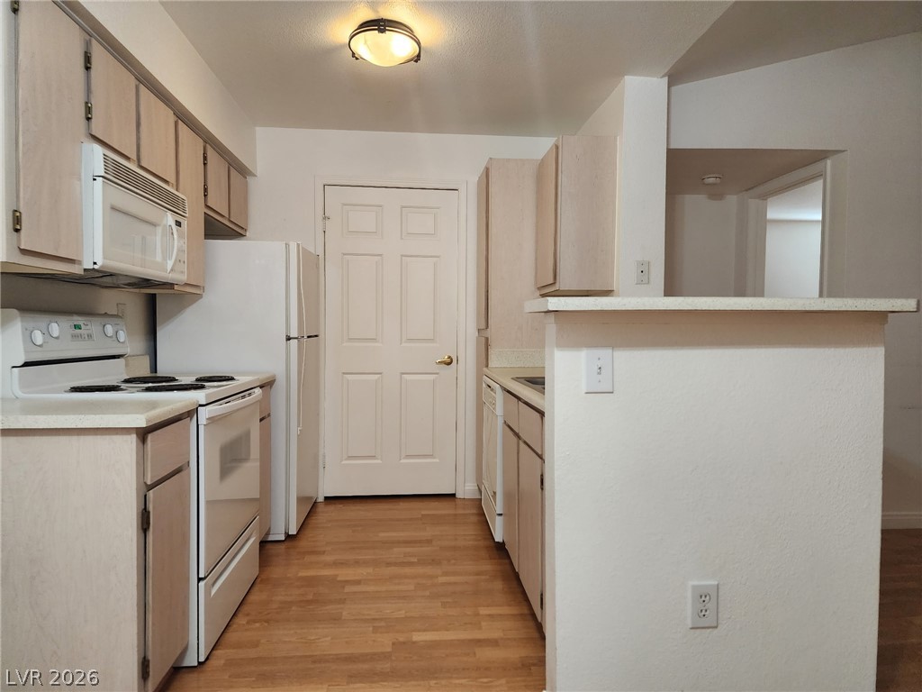 231 West Horizon Ridge Parkway, Unit 1127 Henderson, NV 89012 - Photo 17 of 39 A well-lit kitchen with ample cabinetry and a practical breakfast bar for casual dining.