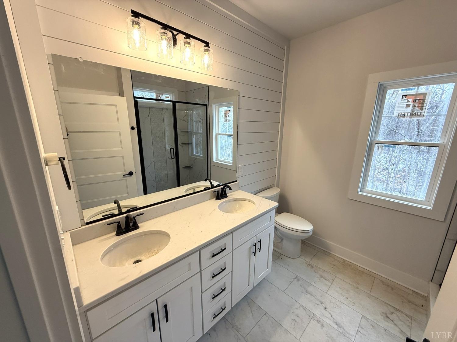 13790 Leesville Road Evington, VA 24550 - Photo 12 of 28 a bathroom with a granite countertop sink toilet and mirror