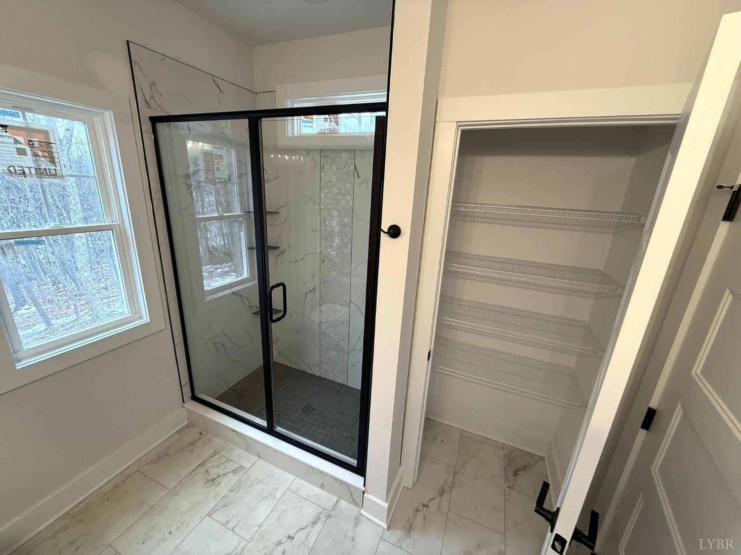 13790 Leesville Road Evington, VA 24550 - Photo 14 of 28 a bathroom with a glass shower door