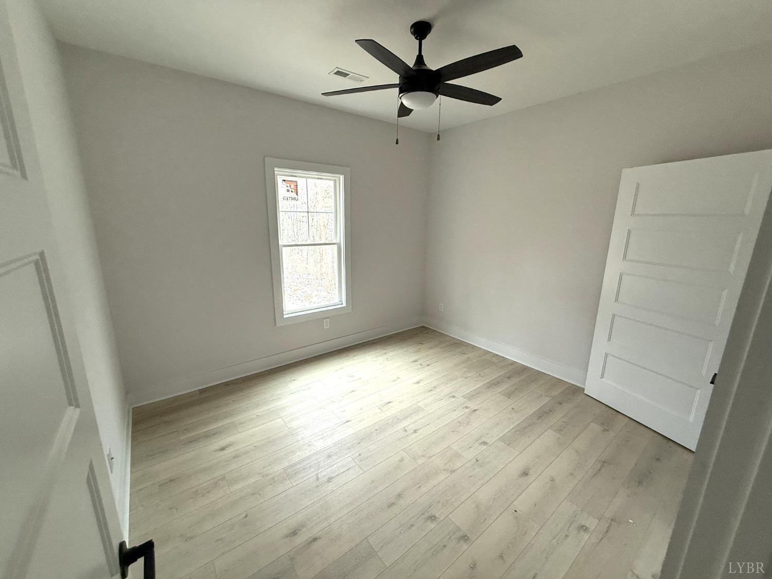 13790 Leesville Road Evington, VA 24550 - Photo 16 of 28 an empty room with a window and a fan