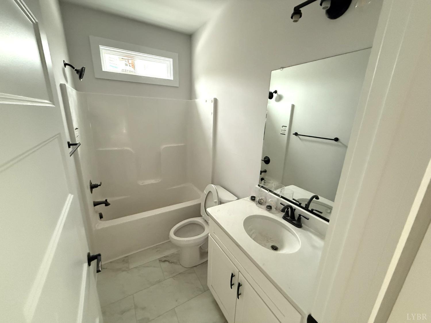 13790 Leesville Road Evington, VA 24550 - Photo 17 of 28 a bathroom with a granite countertop sink toilet and shower
