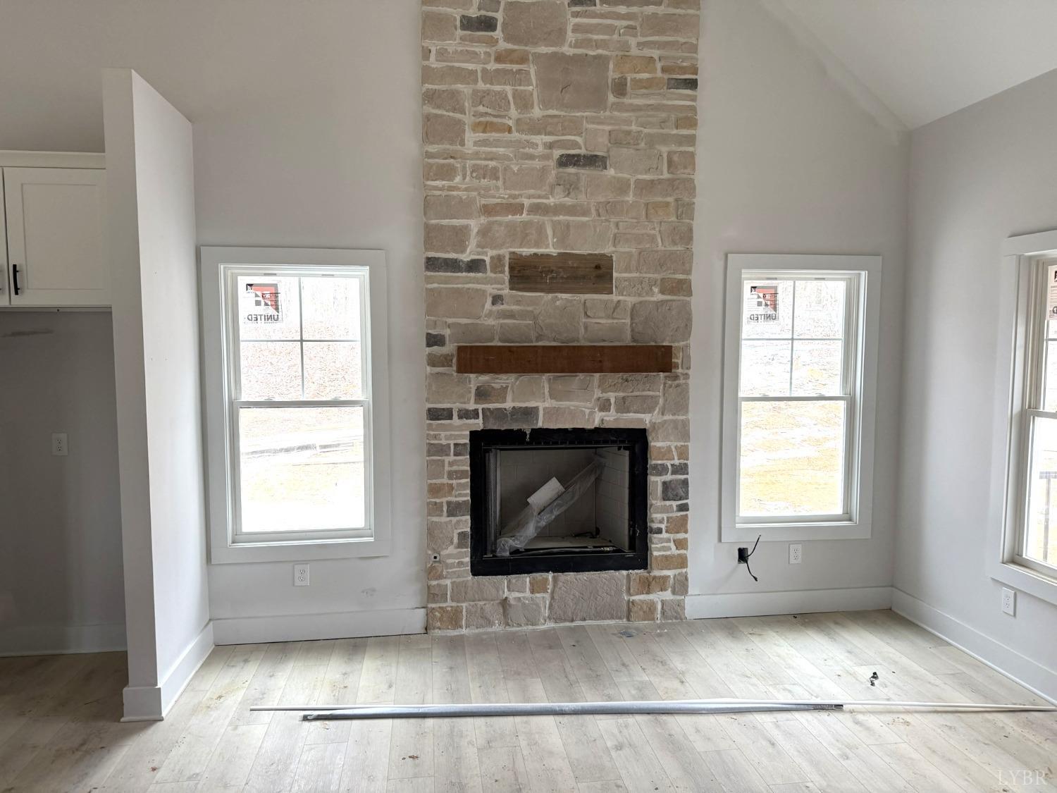 13790 Leesville Road Evington, VA 24550 - Photo 5 of 28 an empty room with windows and fireplace