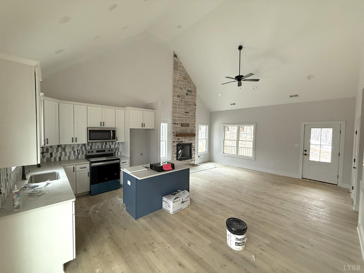 13790 Leesville Road Evington, VA 24550 - Photo 9 of 28 a kitchen with a refrigerator a stove top oven a sink dishwasher and wooden floor