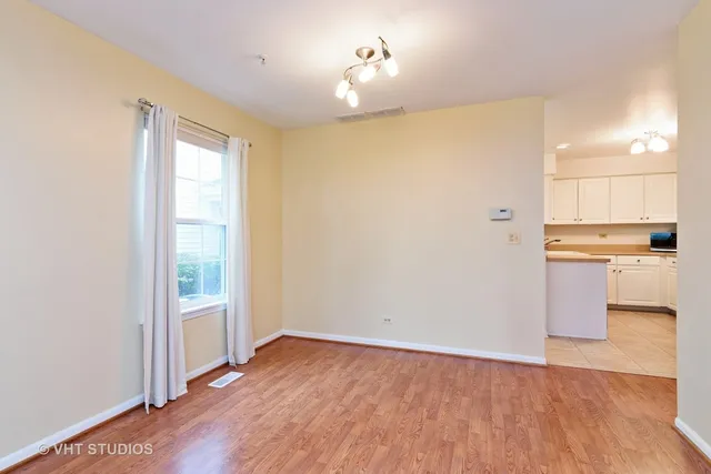 a view of a kitchen with wooden floor and a kitchen