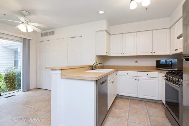a kitchen with a sink stove and cabinets