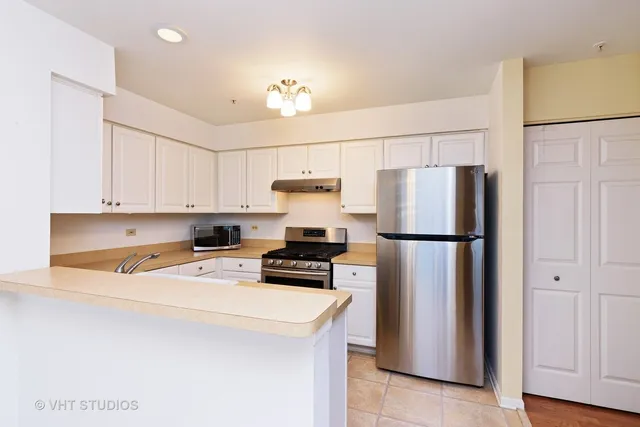 a kitchen with stainless steel appliances a refrigerator a stove a microwave and cabinets