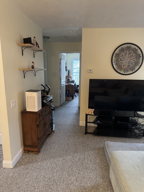 89 Main Street Rowley, MA 01969 - Photo 15 of 39 a living room with furniture and a flat screen tv
