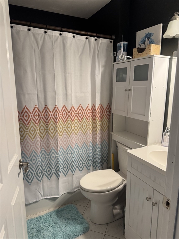 89 Main Street Rowley, MA 01969 - Photo 18 of 39 a bathroom with a toilet and a shower curtain