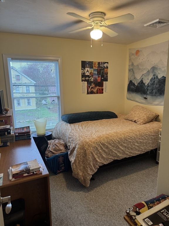 89 Main Street Rowley, MA 01969 - Photo 19 of 39 a bedroom with a bed and ceiling fan