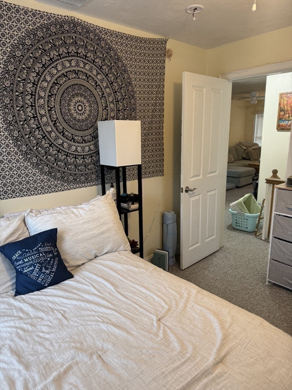 89 Main Street Rowley, MA 01969 - Photo 21 of 39 a bedroom with a bed and a lamp on table