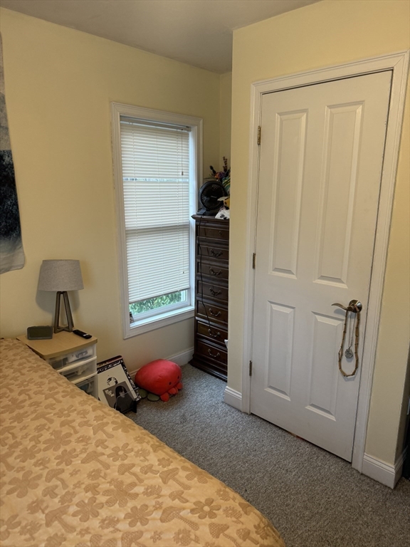 89 Main Street Rowley, MA 01969 - Photo 23 of 39 a bedroom with a bed and a cabinets