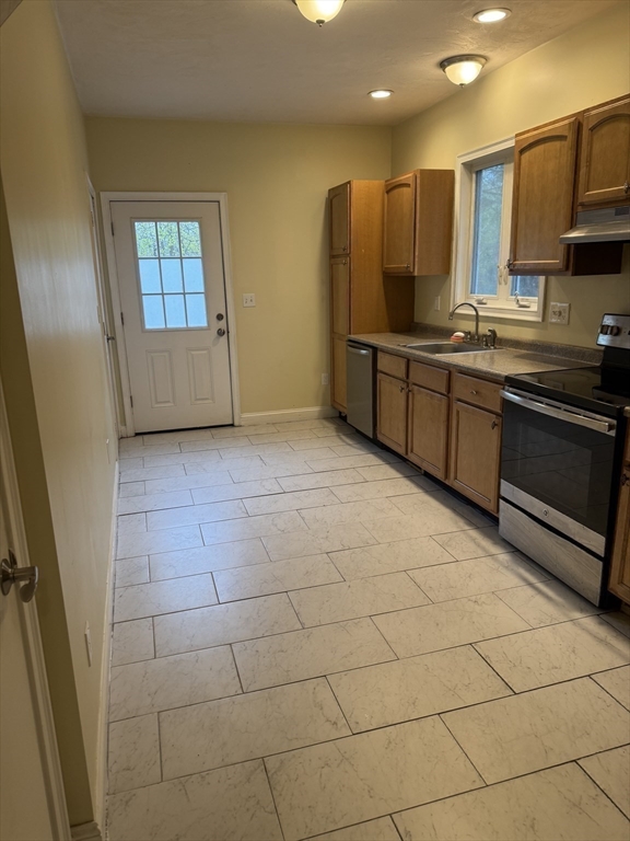 89 Main Street Rowley, MA 01969 - Photo 24 of 39 a kitchen with stainless steel appliances granite countertop a sink and cabinets