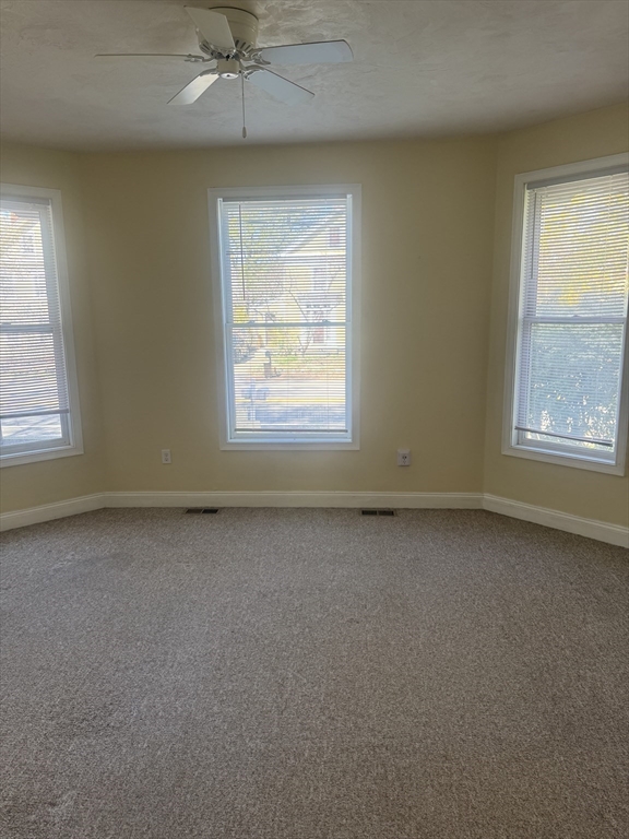 89 Main Street Rowley, MA 01969 - Photo 29 of 39 an empty room with a window and a fireplace