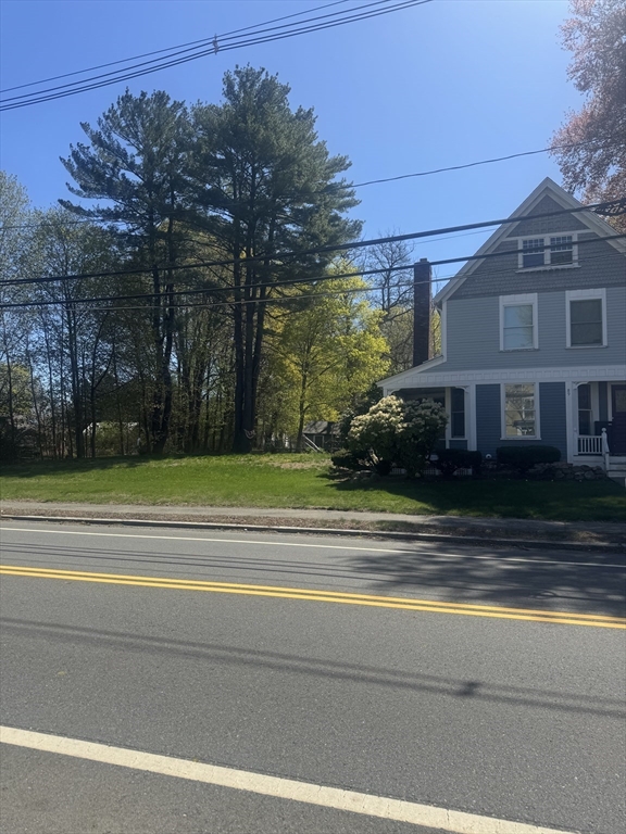 89 Main Street Rowley, MA 01969 - Photo 3 of 39 a view of a house in a big yard with large trees