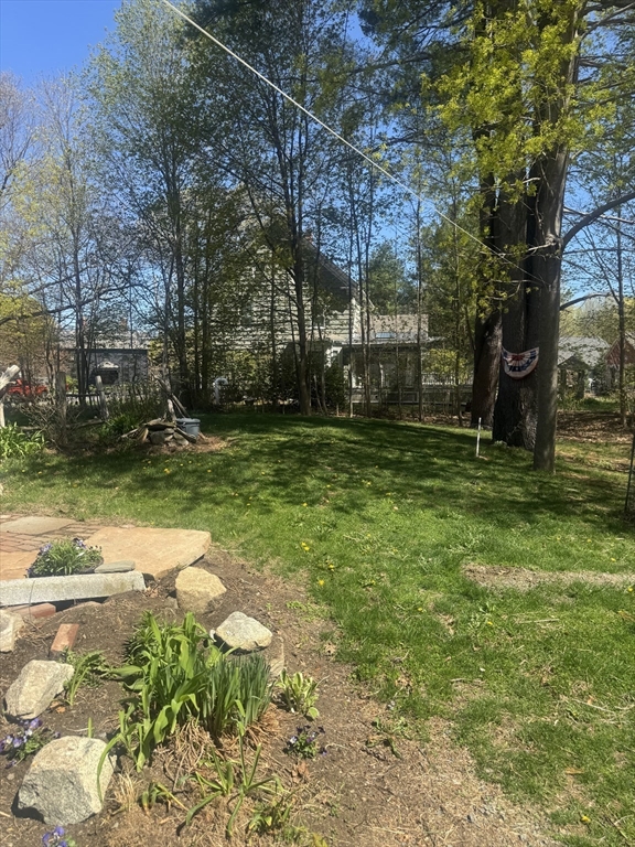 89 Main Street Rowley, MA 01969 - Photo 9 of 39 a backyard of a house with lots of green space