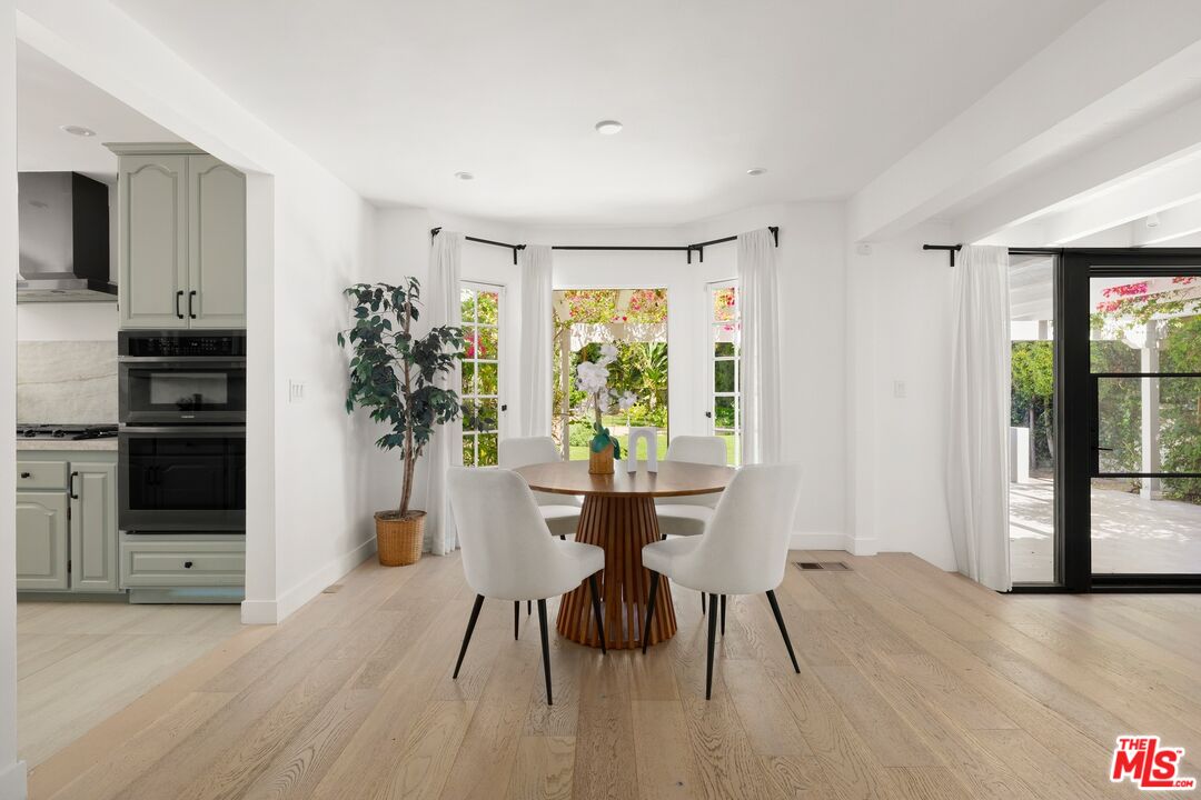 712 North Rodeo Drive Beverly Hills, CA 90210 - Photo 11 of 36 a view of a dining room with furniture window and wooden floor