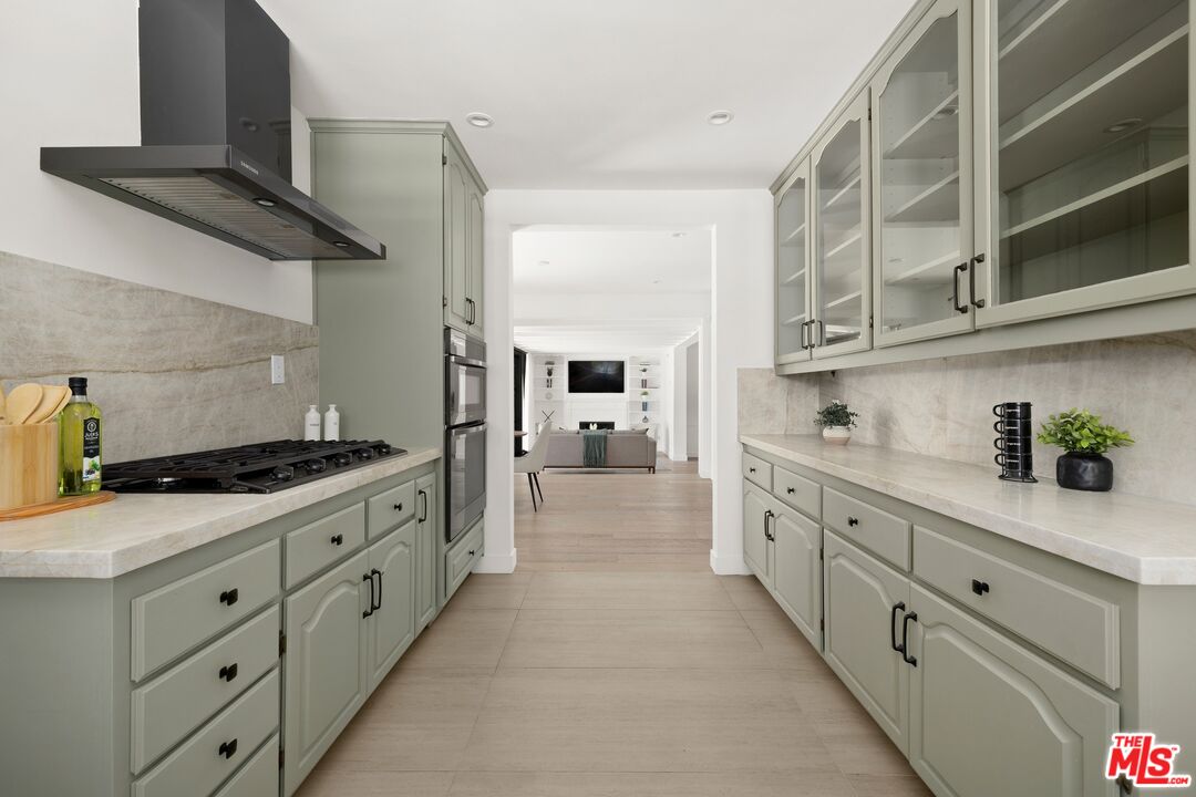 712 North Rodeo Drive Beverly Hills, CA 90210 - Photo 13 of 36 a kitchen with cabinets and a stove