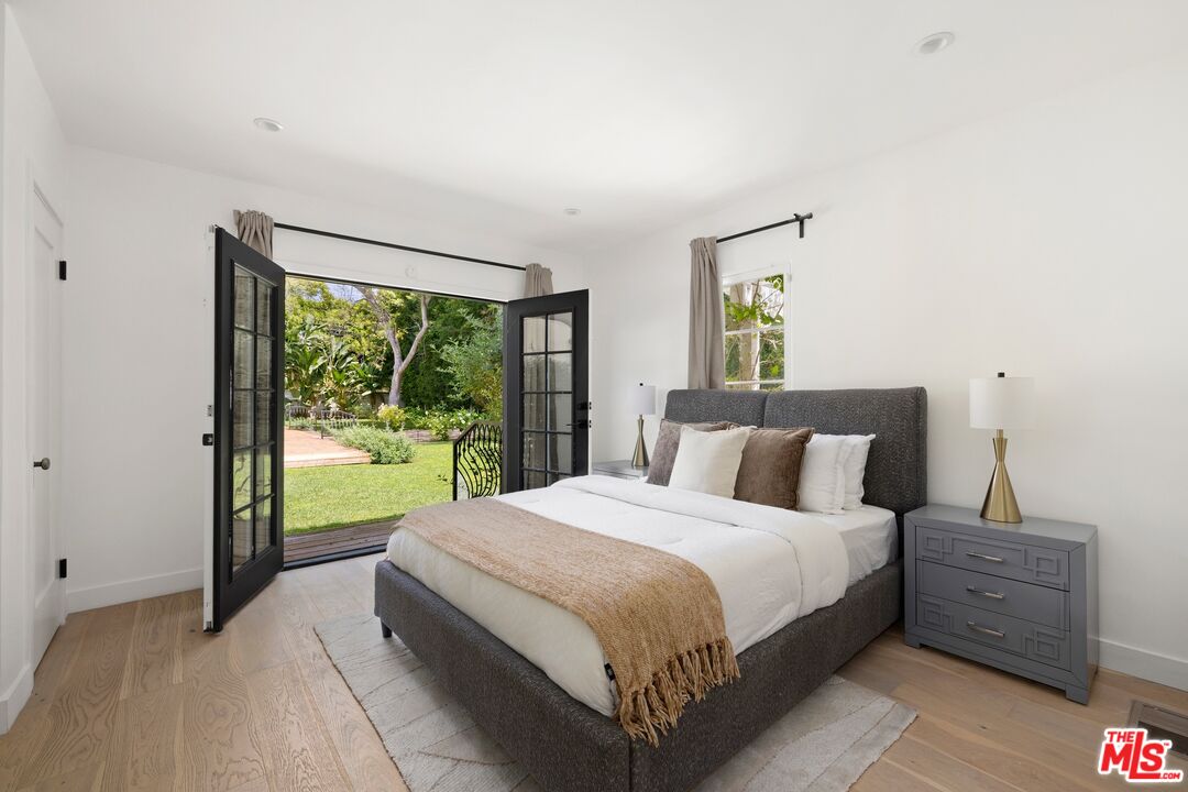 712 North Rodeo Drive Beverly Hills, CA 90210 - Photo 17 of 36 a bedroom with a large bed and a window