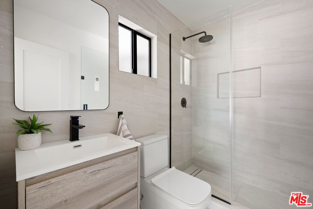 712 North Rodeo Drive Beverly Hills, CA 90210 - Photo 18 of 36 a bathroom with a sink toilet and shower