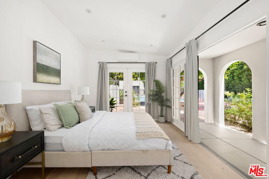 712 North Rodeo Drive Beverly Hills, CA 90210 - Photo 19 of 36 a bedroom with a bed mirror and window