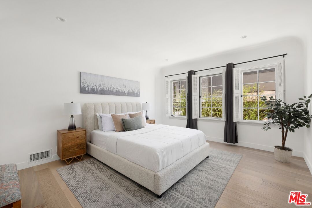 712 North Rodeo Drive Beverly Hills, CA 90210 - Photo 24 of 36 a bedroom with a large bed and a window