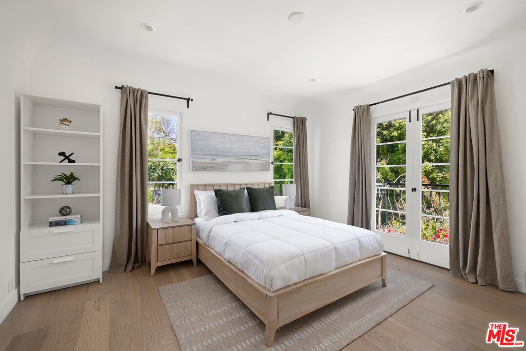 712 North Rodeo Drive Beverly Hills, CA 90210 - Photo 26 of 36 a bedroom with a large bed and a window