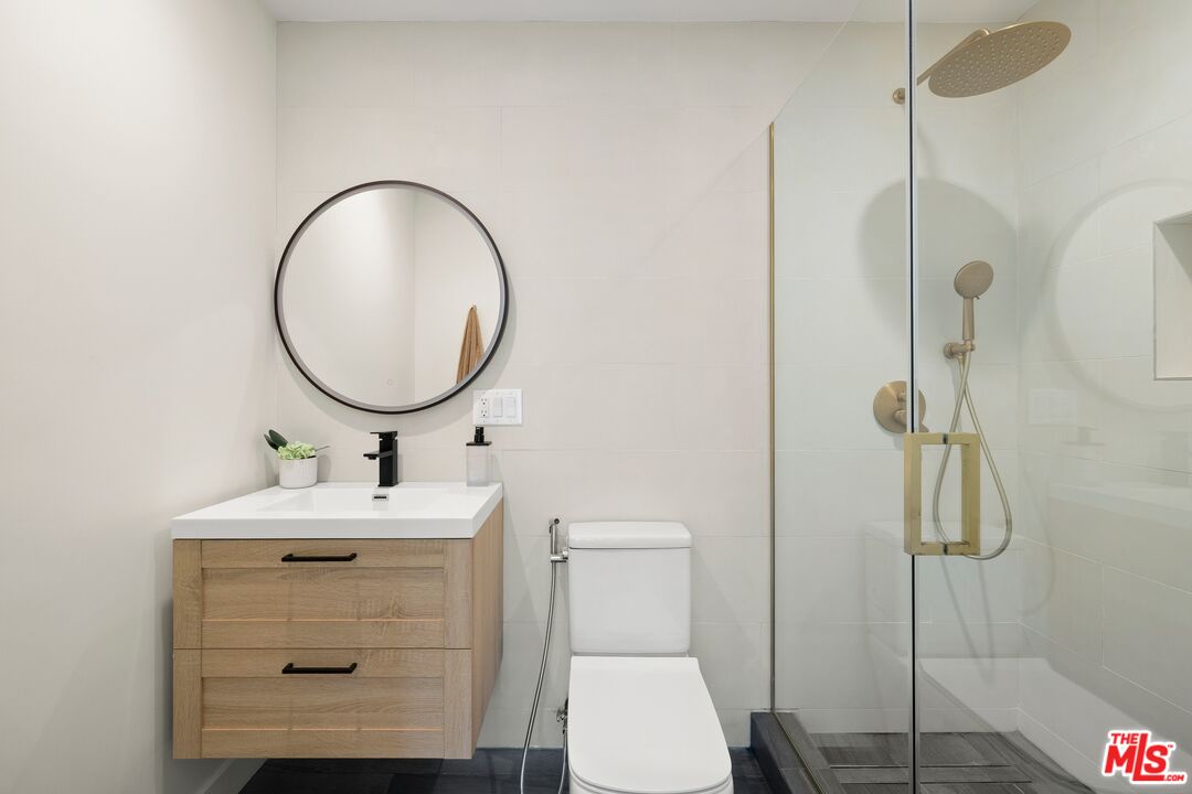 712 North Rodeo Drive Beverly Hills, CA 90210 - Photo 27 of 36 a bathroom with a sink mirror toilet and shower