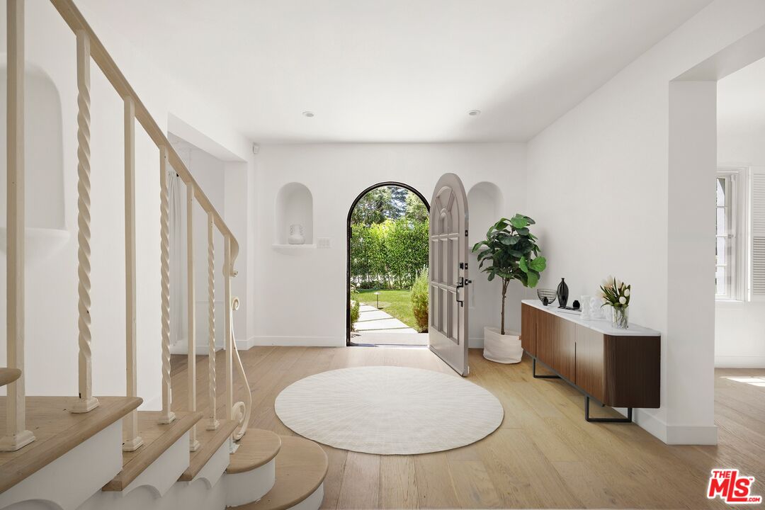 712 North Rodeo Drive Beverly Hills, CA 90210 - Photo 4 of 36 a view of an entryway with wooden floor