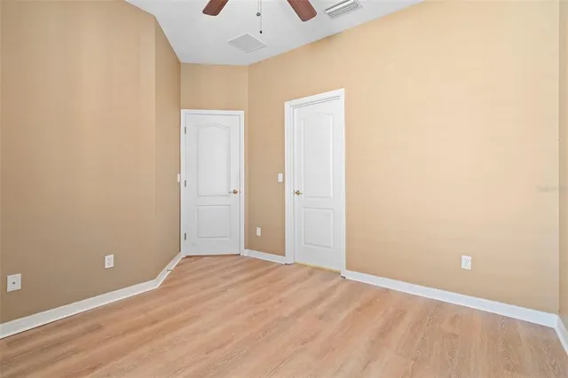 a view of a room with wooden floor and a window