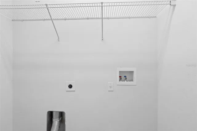 a view of a big room with windows and chandelier