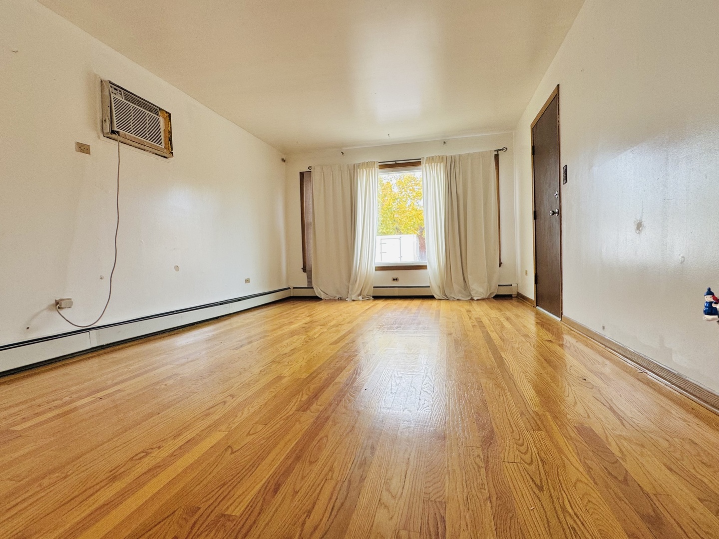 4211 West 63rd Street, Unit 1 Chicago, IL 60629 - Photo 2 of 13 a view of an empty room with wooden floor