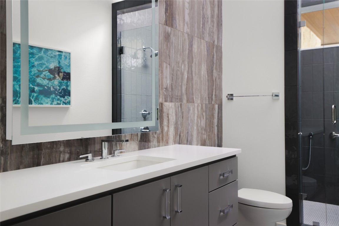 12900 Hacienda Ridge Austin, TX 78738 - Photo 26 of 40 a bathroom with a sink a toilet a shower and a large mirror