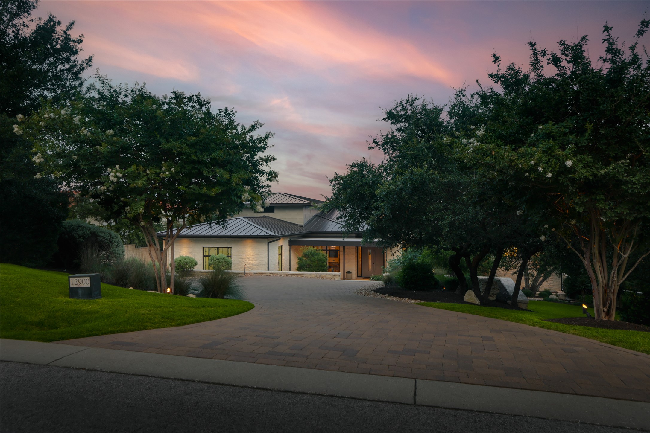 12900 Hacienda Ridge Austin, TX 78738 - Photo 3 of 40 a front view of a house with a yard and trees
