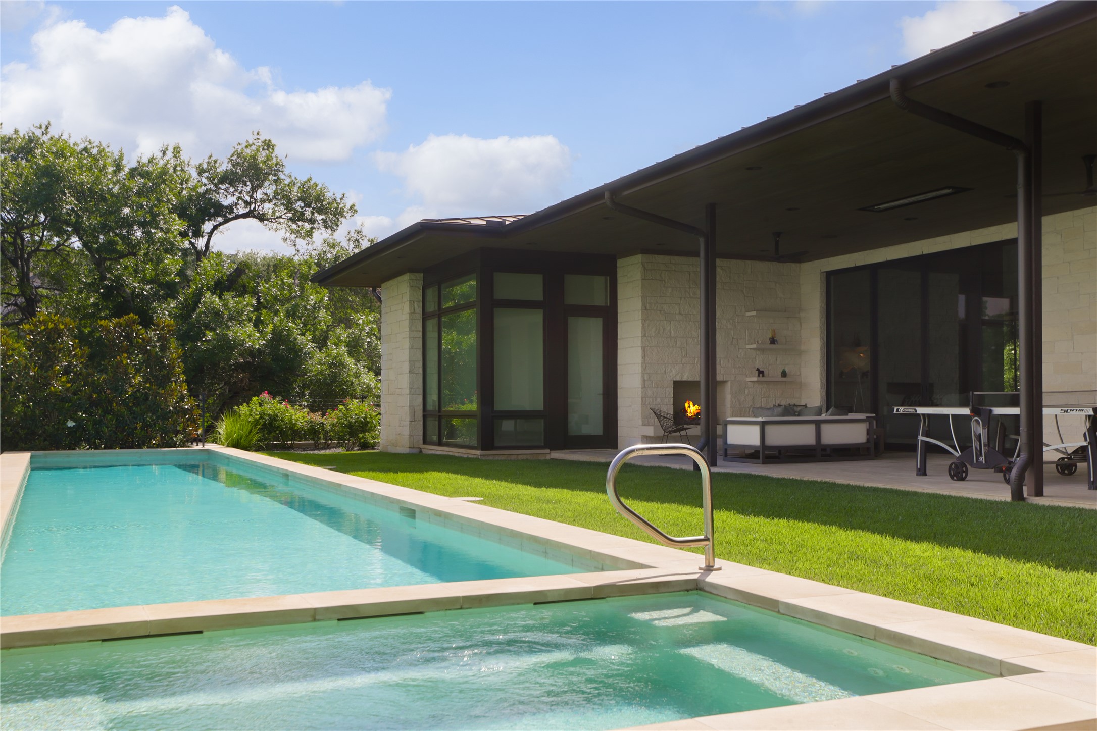 12900 Hacienda Ridge Austin, TX 78738 - Photo 36 of 40 a view of a backyard with table and chairs under an umbrella