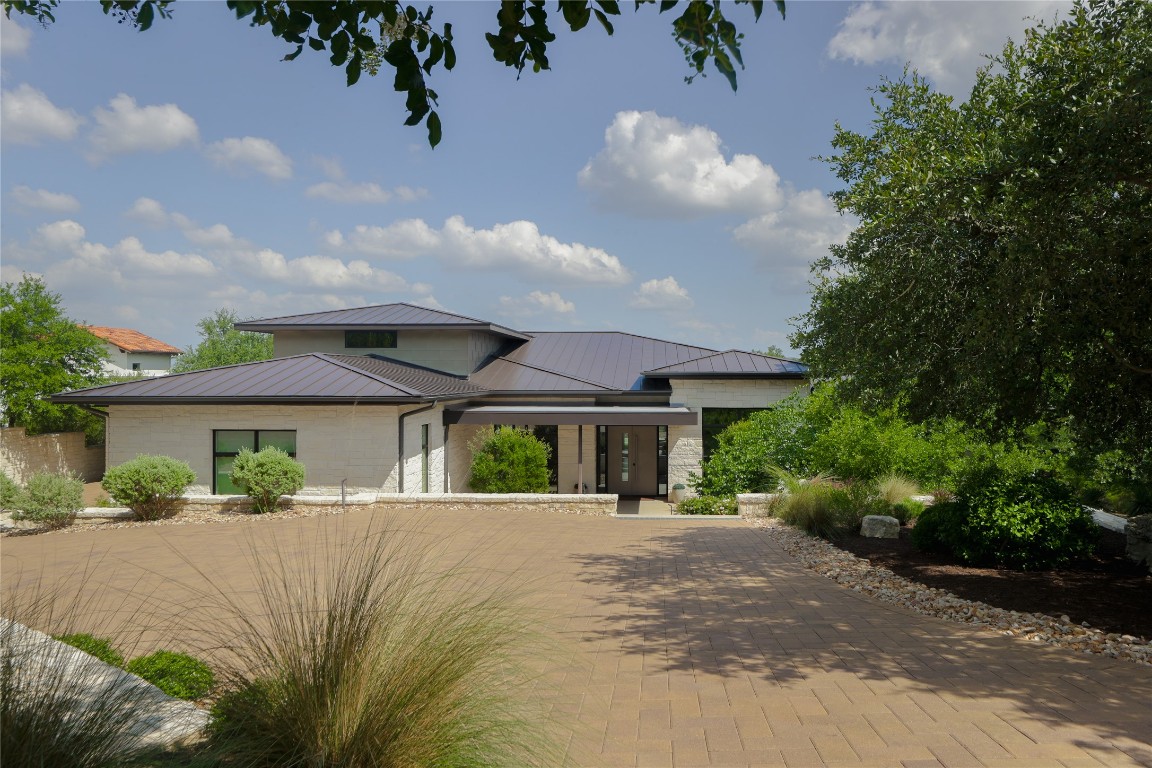 12900 Hacienda Ridge Austin, TX 78738 - Photo 4 of 40 a front view of house with yard and green space