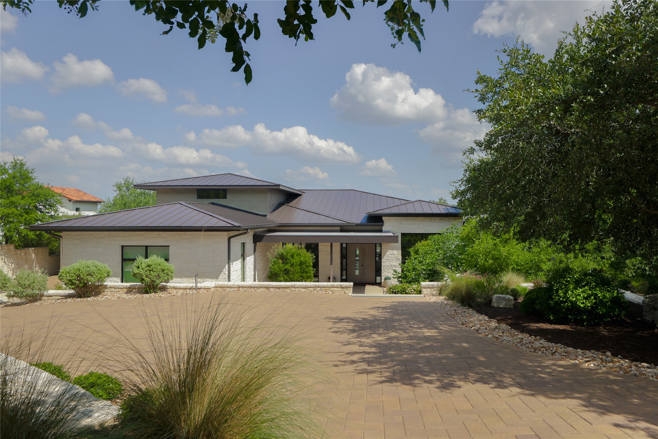 12900 Hacienda Ridge Austin, TX 78738 - Photo 4 of 40 a front view of house with yard and green space