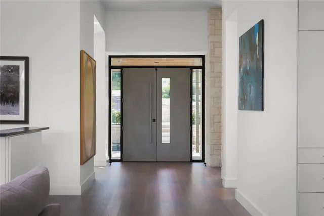 a view of a livingroom with wooden floor and windows