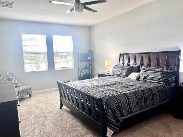 a bed sitting in a bedroom next to a window