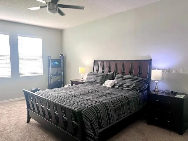 a bathroom with double vanity sinks a mirror and a bathtub