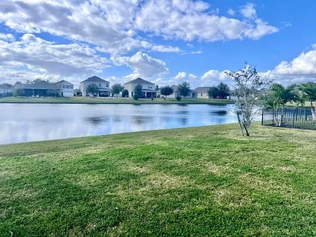 a view of lake with houses in the back