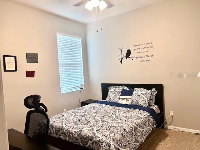 a living room with a black white checkered table and a fireplace