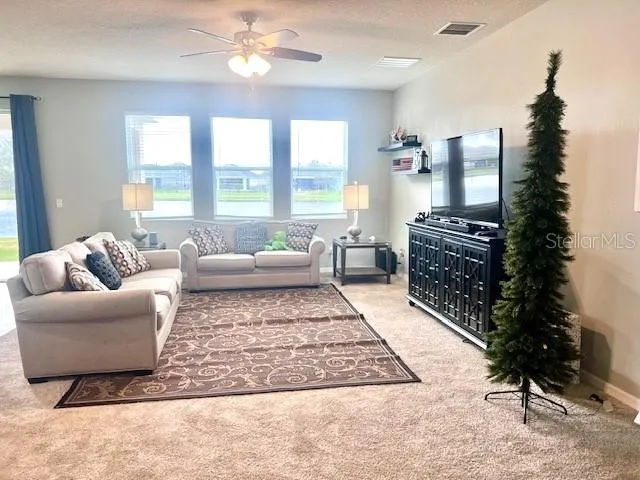 a living room with furniture and a large window