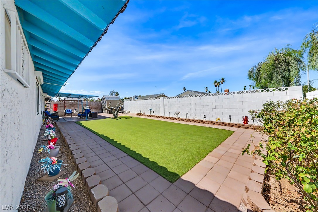 3107 Trueno Road Henderson, NV 89014 - Photo 35 of 37 A private yard boasts a neatly maintained lawn, perfect for outdoor enjoyment and relaxation.