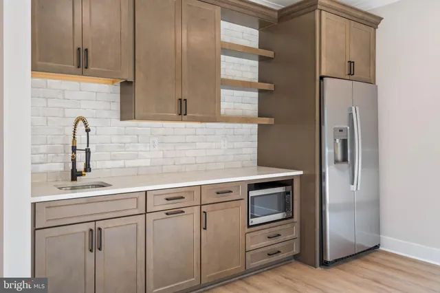 a kitchen with white cabinets and a sink