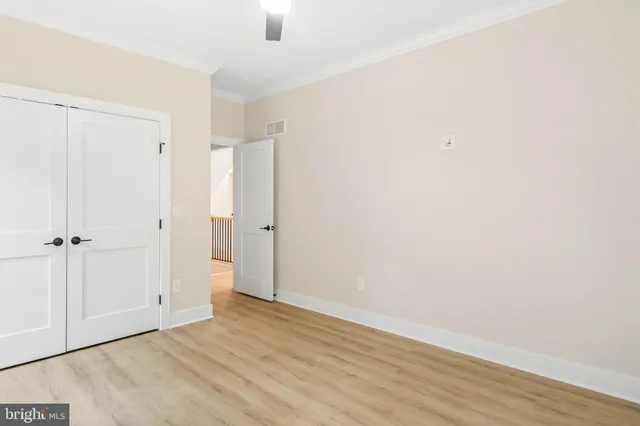 an empty room with wooden floor