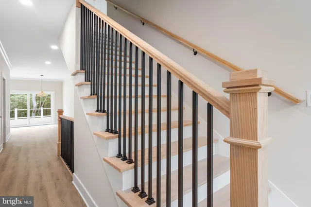 a view of entryway with wooden floor and stairs